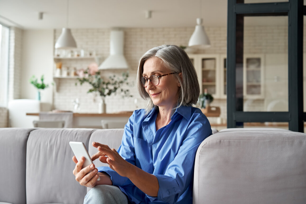 Female customer holding smartphone using a banking mobile app.